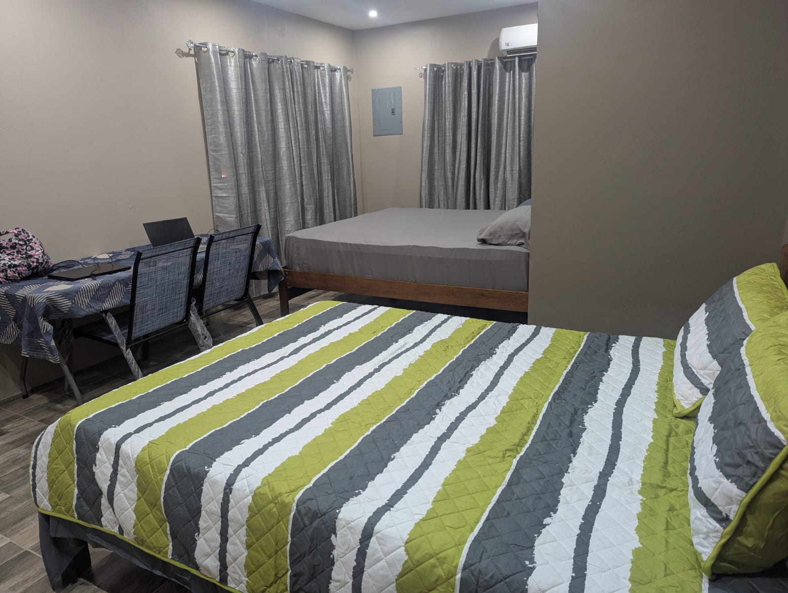 Upstairs bedroom with king and queen beds at Rachel's Retreat Mayaro